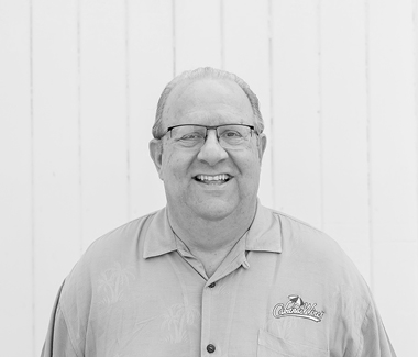 Smiling man wearing glasses and a polo shirt with Lodi Winegrape Commission logo.