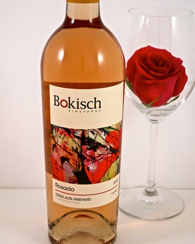 Bottle of Rosado wine from Lodi Winegrape Commission with a red rose in a glass.