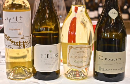 Four wine bottles from Lodi Winegrape Commission showcasing different varieties and vintages.