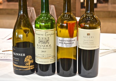 Four wine bottles from Lodi Winegrape Commission showcasing different varieties and vintages.