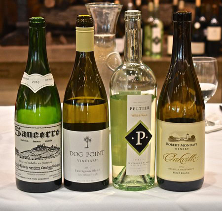 Four wine bottles from Lodi Winegrape Commission showcasing different varieties and labels.