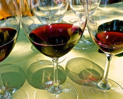 Multiple glasses of red wine on a table, showcasing Lodi Winegrape Commission's wine selection and tasting experience.