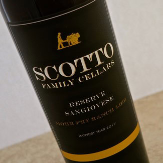 Close-up of Scotto Family Cellars Sangiovese Reserve wine bottle with label details.