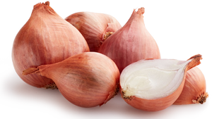 Close-up of fresh red onions with papery skin and one cut open showing white flesh.