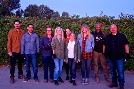 Group photo of Lodi Winegrape Commission members standing outdoors in front of grapevines.