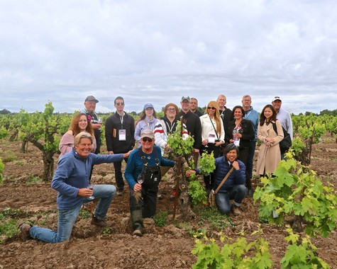 Group of people in a vineyard during a wine industry event in Lodi, California.