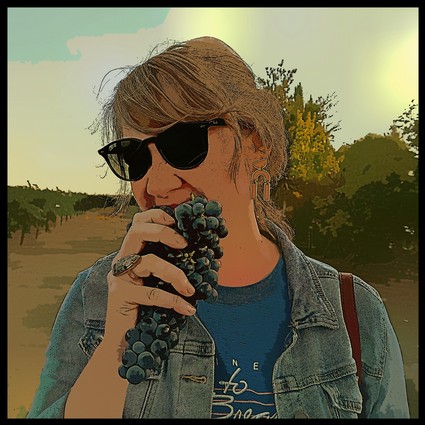Woman tasting grapes in a vineyard, promoting Lodi Winegrape Commission and local wine industry.