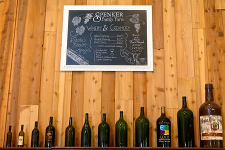 Chalkboard menu at Spenker Family Farm Winery showcasing wine options and prices.
