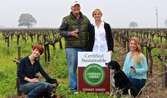 Group of people at a vineyard with a sign for certified sustainable winegrowing practices.