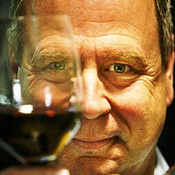 Close-up of a man enjoying a glass of red wine, highlighting Lodi Winegrape Commission's wine quality and tasting experience.