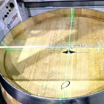 Close-up of a wine barrel with green laser lines for quality inspection at Lodi Winegrape Commission.