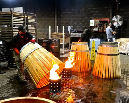 Winery workers toast oak barrels for wine aging at Lodi Winegrape Commission facility.