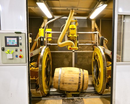 Automated wine barrel handling machine at Lodi Winegrape Commission facility for efficient wine production.