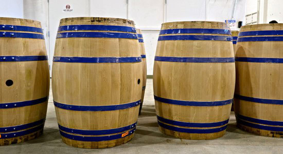 Wooden wine barrels with blue metal hoops at Lodi Winegrape Commission facility.