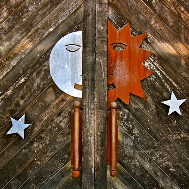 Decorative wooden door with sun and moon metal art for Lodi Winegrape Commission.