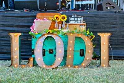 Decorative LODI sign with sunflowers and lights at a wine event in Lodi, California.
