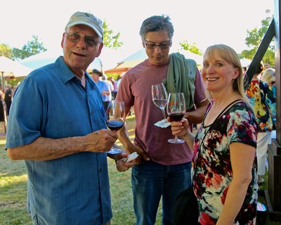 People enjoying wine tasting at a Lodi Winegrape Commission outdoor event.