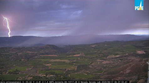 Vast vineyard landscape in Lodi with stormy sky and lightning in the background.