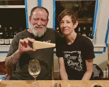 Two people enjoying wine and cheese at a Lodi Winegrape Commission event.