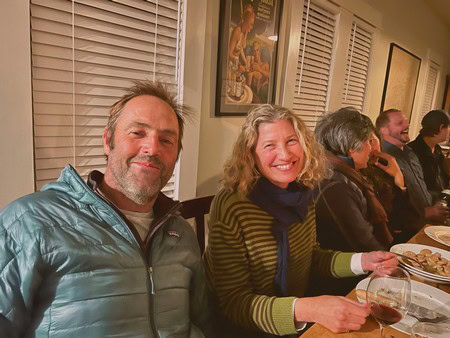 Smiling attendees at a Lodi Winegrape Commission gathering enjoying wine and conversation.