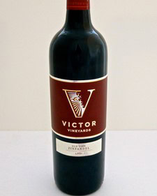 Bottle of Victor Vineyard wine from Lodi, California, with a red and white label.