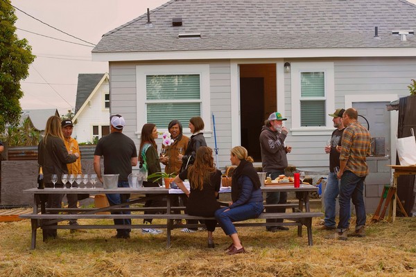 Group of people gathered outdoors at a community event hosted by the Lodi Winegrape Commission.