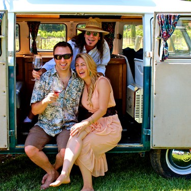 Group of friends enjoying wine and sunshine at a vineyard event in Lodi, California.