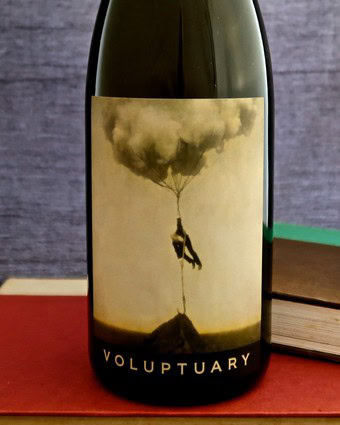Artistic wine bottle label featuring a person hanging from a cloud-shaped balloon.