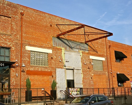 Historic brick building of the Lodi Winegrape Commission with industrial design and outdoor decor.