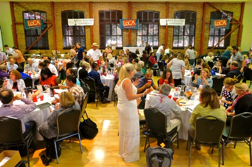 Large gathering at Lodi Winegrape Commission event with attendees tasting and discussing wines in a spacious hall.