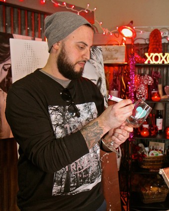 Man with beard and gray beanie using smartphone at Lodi Winegrape Commission event.