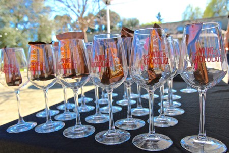 Multiple wine glasses with chocolate, showcasing Lodi Winegrape Commission's wine tasting event.