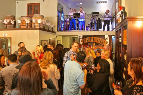 Crowd enjoying wine tasting at Lodi Winegrape Commission event with live music and socializing.