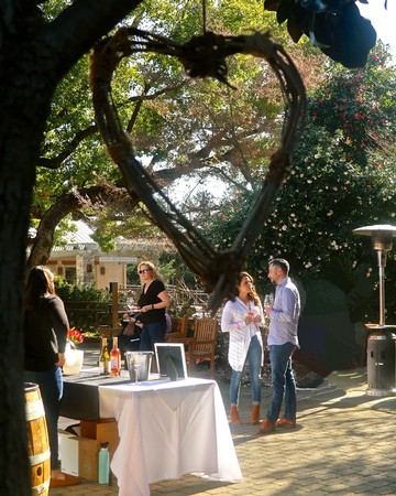 Heart-shaped grapevine wreath hanging outdoors at a wine event in Lodi, California.