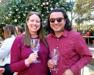 Smiling woman and man enjoying wine at Lodi Winegrape Commission event.