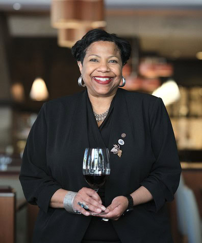 Woman holding a glass of red wine at a Lodi Winegrape Commission event.