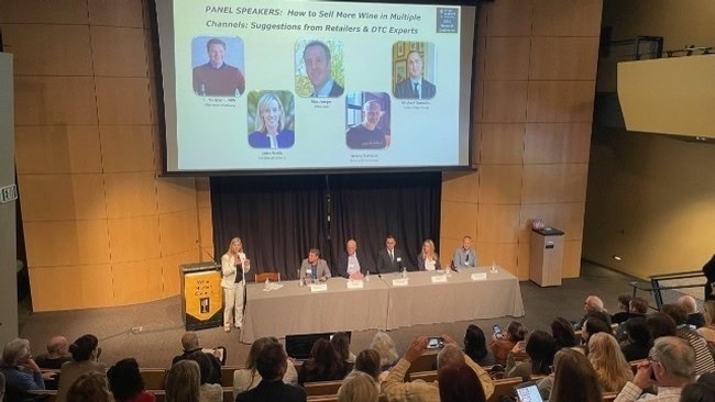 Panel discussion at Lodi Winegrape Commission event with speakers and audience.