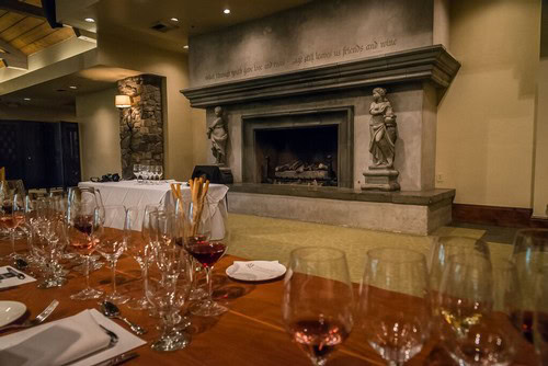 Sophisticated dining setup with wine glasses and a fireplace in a luxurious restaurant setting.