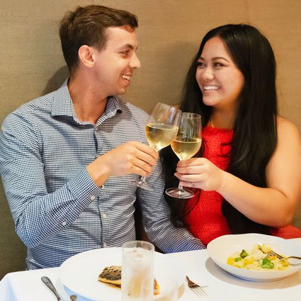 Couple enjoying wine and dinner at Lodi Winegrape Commission event.