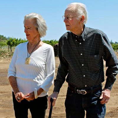 Elderly man and woman walking in a vineyard, enjoying the outdoors in Lodi, California.