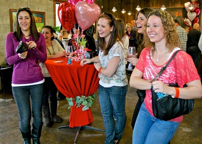 Group of women celebrating at a Lodi Winegrape Commission event with balloons and wine glasses.