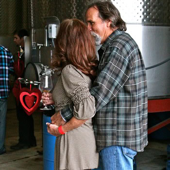 Couple embracing at Lodi Winegrape Commission event, showcasing connection and celebration in wine industry.