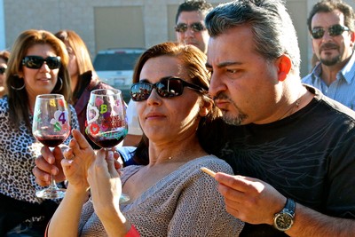Group of people enjoying wine tasting at Lodi Winegrape Commission event.