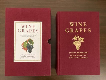 Close-up of a red hardcover book titled 'Wine Grapes' by Jancis Robinson and Julia Harding.