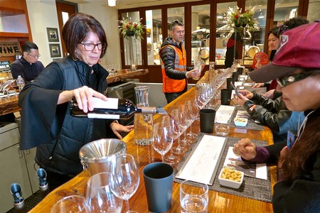 Wine tasting at Lodi Winegrape Commission with attendees sampling wines at a bar.