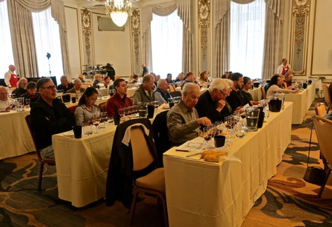Attendees at a wine industry conference in an elegant, historic ballroom setting.