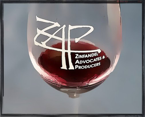 Close-up of a wine glass with Lodi Winegrape Commission logo and red wine inside.