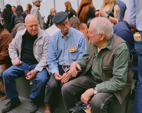 People enjoying wine tasting at a Lodi Winegrape Commission event with conversations and socializing.