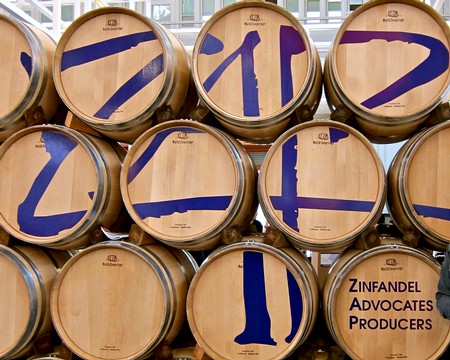 Wooden wine barrels with blue painted numbers and text for Zinfandel advocates and producers in Lodi, California.