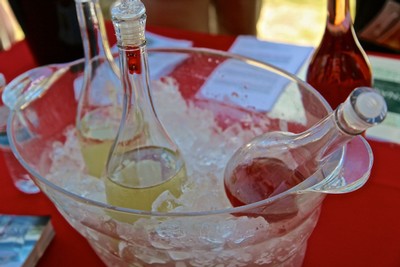Glass bottles in an ice bucket at a wine tasting event, showcasing Lodi winegrapes.